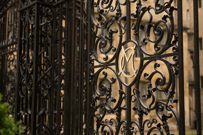 A close up image Merton College gate with a close up of the M